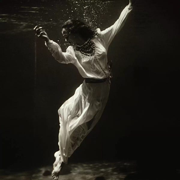 Fashion Photography: Fashion Model Underwater in Dolphin Tank (MarinelandFlorida) by Toni Frissell