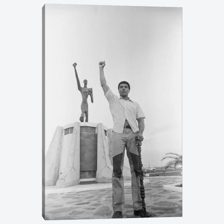 Muhammad Ali Posing In Front Of The Le Militant Statue, Kinshasa, Zaire Canvas Print #ALI47} by Muhammad Ali Enterprises Art Print