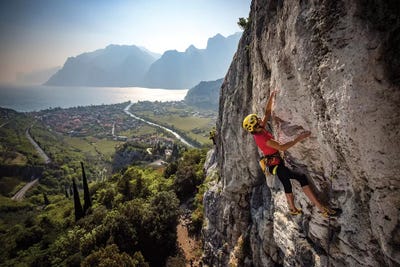 A Climber Above The Town Of Arco And Lago di Garda, Italy by Alex Buisse framed canvas print