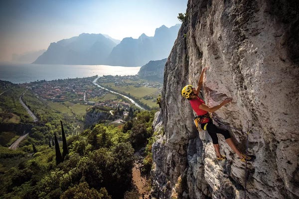 Alex Buisse: A Climber Above The Town Of Arco And Lago di Garda, Italy by Alex Buisse