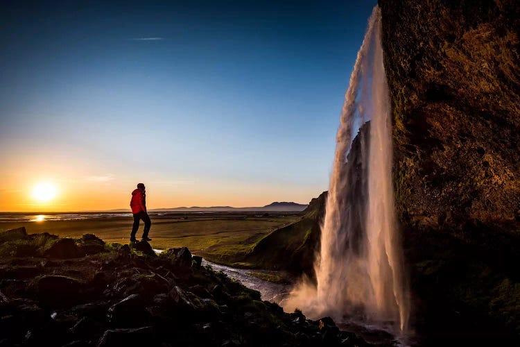 A Lone Figure In Front Of Seljalandfoss, Sudurland, Iceland, At Midnight