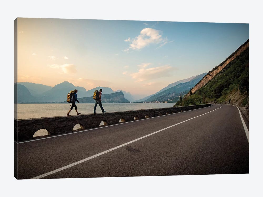 Two Climbers Walk Home Next To A Road And Lago di Gardo, Arco, Trentino, Italy 1-piece Canvas Art