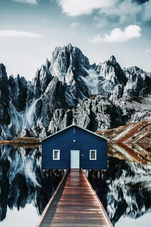 The Reflection Of A Cabin In The Mountains In The Water