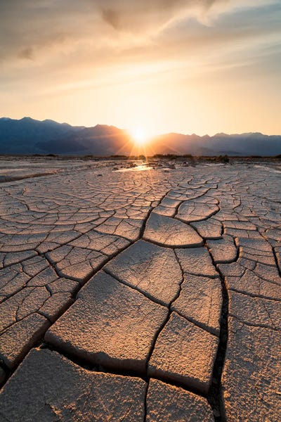 Sun Setting Beyond The Intricate Mud Cracks Of Death Valley by Alexander Sloutsky canvas print
