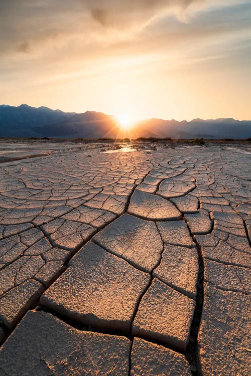 Sun Setting Beyond The Intricate Mud Cracks Of Death Valley