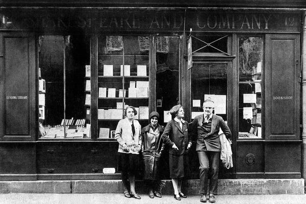 Rue Des Archives: Ernest Hemingway and Sylvia Beach infront of the 'Shakespeare and Company' bookshop, Paris, 1928  by Rue Des Archives