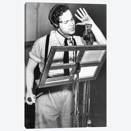 Orson Welles reading text of "War of the Worlds" by HG Wells during CBS radio broadcast in October 1938 Canvas Print #BMN8625} by Rue Des Archives Canvas Print
