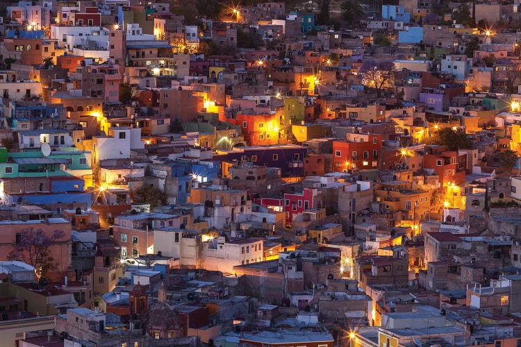 Mexico, Guanajuato. Street lights add ambience to this twilight village scene.