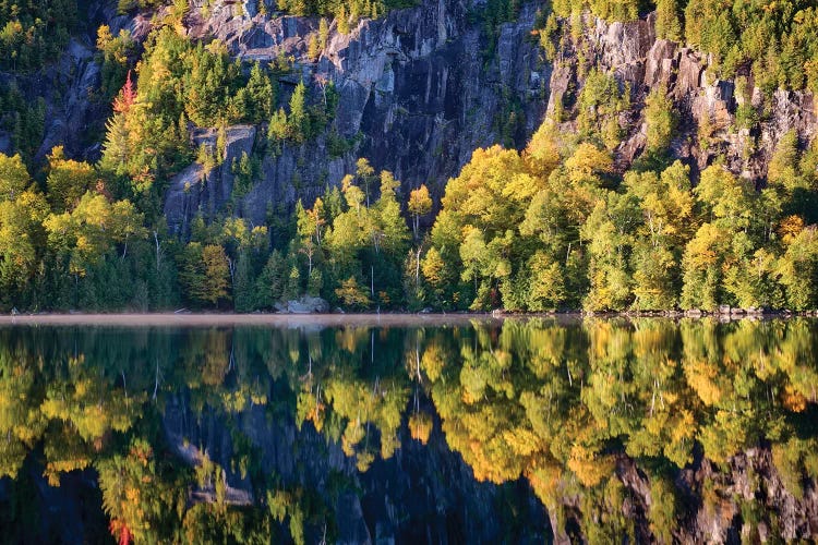 USA, New York State. Autumn reflections in Chapel Pond, Adirondack Mountains.