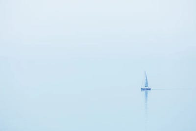 A Sailboat At The Foggy Coast In France by Daniel Gastager framed canvas print