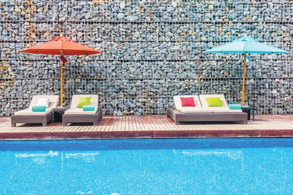 DepositPhotos: Umbrella And Chair Around Swimming Pool by mrsiraphol