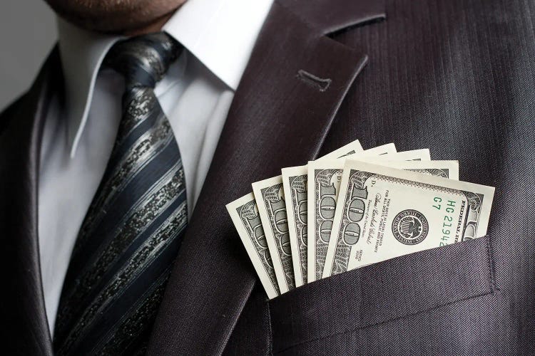 Businessman With Money In Suit Pocket