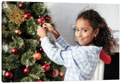 Adorable Child In Pajamas Decorating Christmas Tree With Baubles Canvas Art Print
