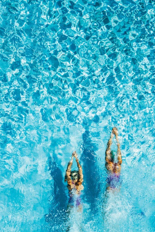 Two Women Swimming In A Pool, Seen From Above