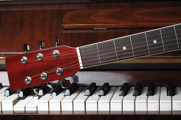 DepositPhotos: Guitar Neck On Old Piano Keys by flowerstock