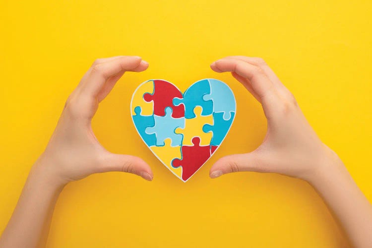 World Autism Awareness Day - Female Hands Around A Heart Puzzle Symbol by VadimVasenin wall art