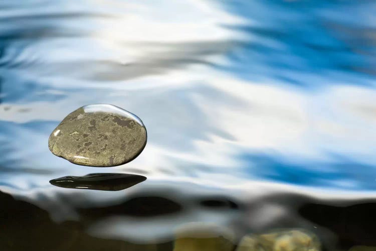 Skipping Stone Just About To Hit The Water's Surface