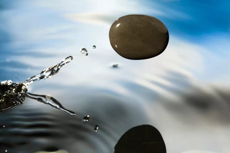 A Rock Skipping Across The Water's Surface