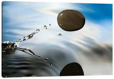 A Rock Skipping Across The Water's Surface Canvas Art Print