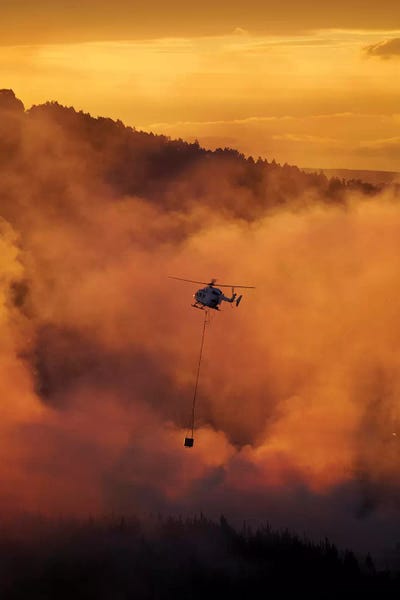 David Wall: Smokey Sunset And Helicopter Fighting Fire At Burnside, Dunedin, South Island, New Zealand by David Wall
