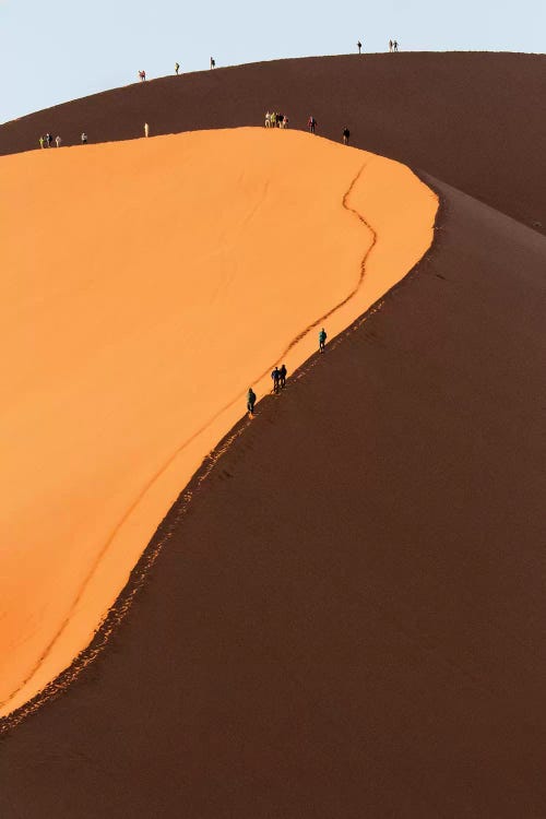 Africa, Namib Desert. Hikers climbing the red sand dune in Namibia.