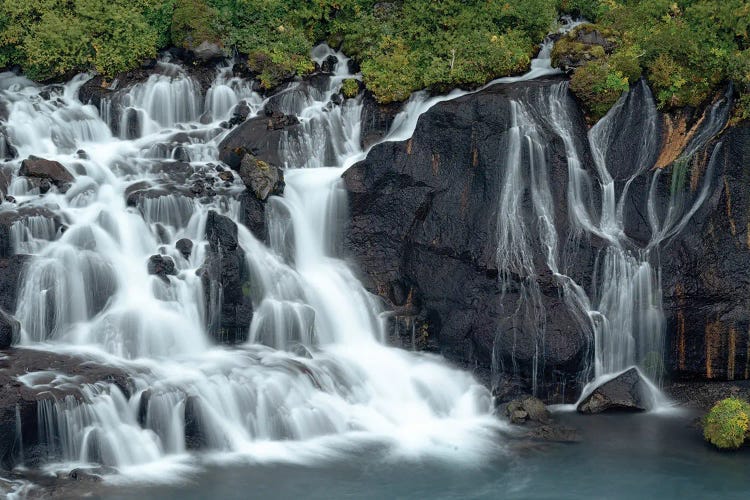 Iceland, Hraunfossar. Tiny cascades emerge from the lava to flow into the Hvita River over a half mile stretch.