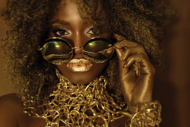 Beautiful African American Woman Wearing Gold Makeup Looking Above Sunglasses