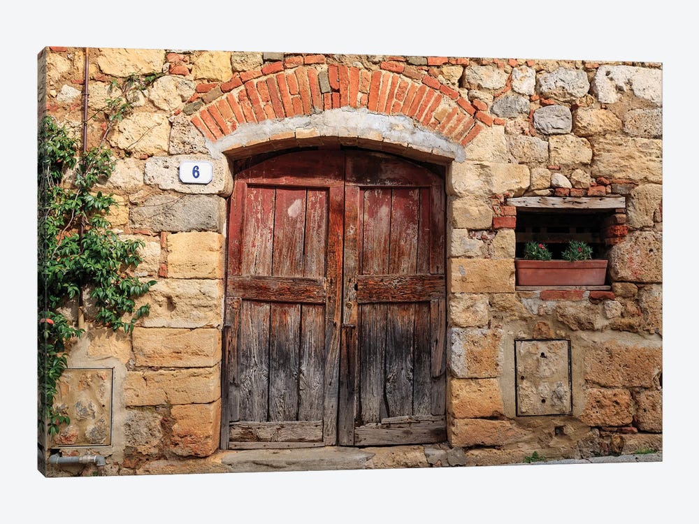 Italy, Monteriggioni. Stone wall, wooden door with planted geraniums. by Emily Wilson 1-piece Canvas Print