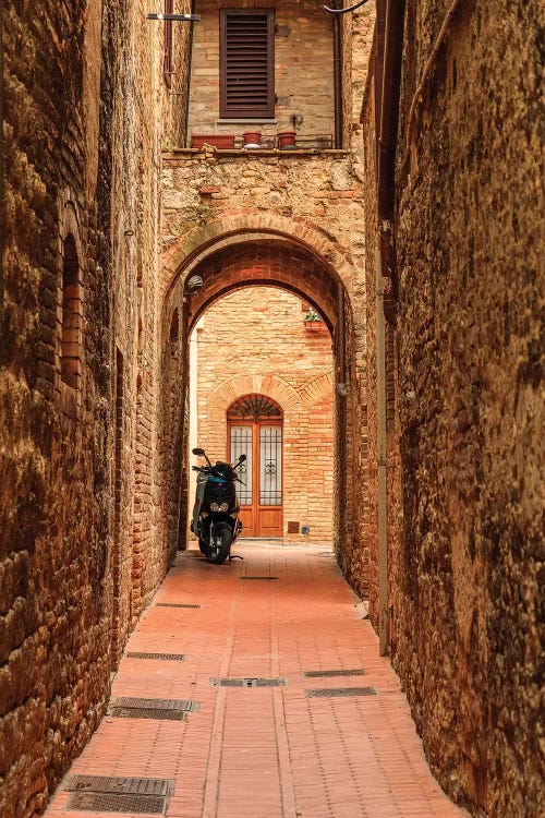 Italy, San Gimignano. Alleyway with motorbike.