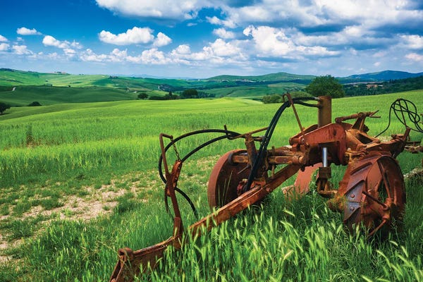 Soil Tilling Machine On A Farmland With Wheat Field, San Qurico D'Orcia, Tuscany, Italy