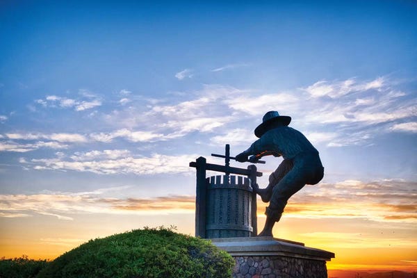 George Oze: The Grape Crusher Statue Agains Dramatic Sky, Napa Valley, California by George Oze