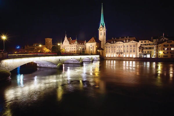 Nighttime View Of The Fraumunster Abbey With The Munster Bridge, Zurich, Switzerland