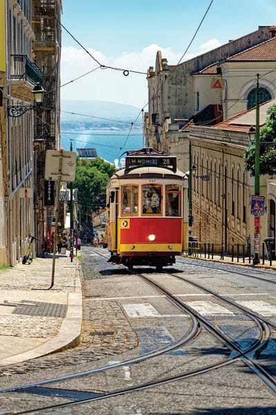 Lisbon: The Classic Tram 28 Climbing Up The Hill In The Amalfa District, Lisbon, Portugal by George Oze