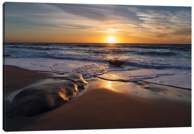 Sunset reflecting off the water on the sand of a beach Canvas Art Print - Calm Art