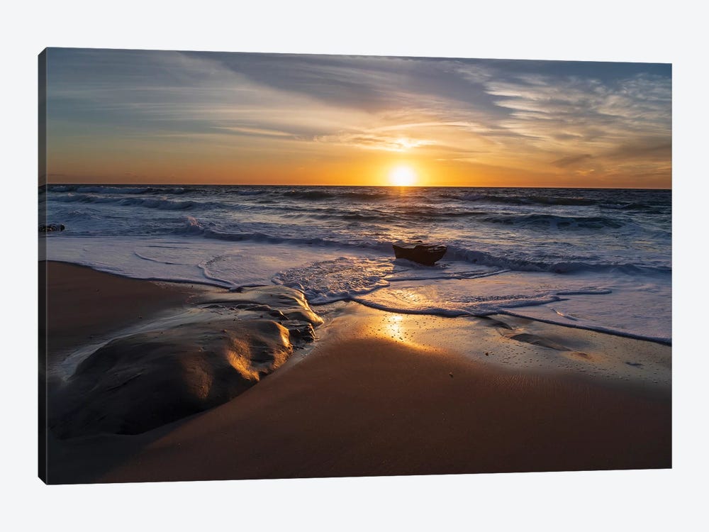 Sunset reflecting off the water on the sand of a beach by Sheila Haddad 1-piece Art Print