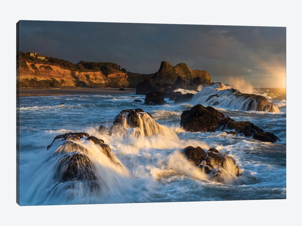 Waves crashing on rocks and washing down the sides at sunset by Sheila Haddad 1-piece Canvas Print