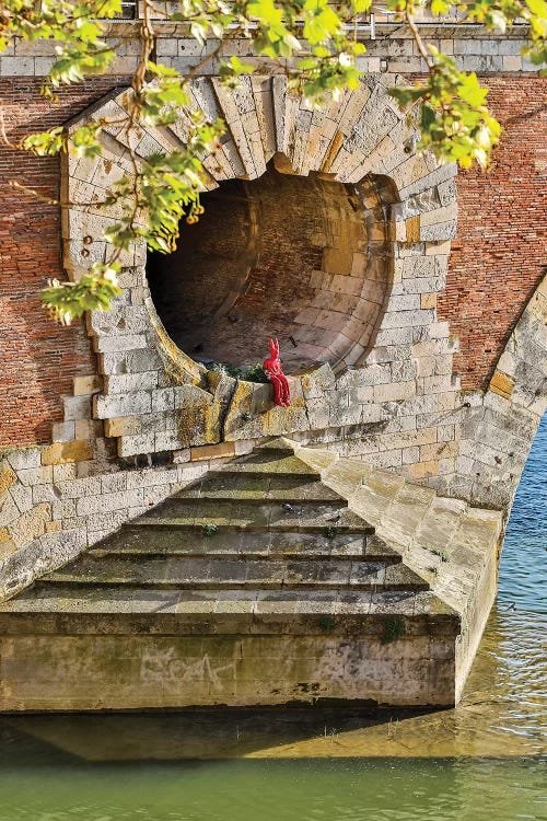 France, Toulouse. Red Devil sitting in opening of the Pont Neuf (Bridge)