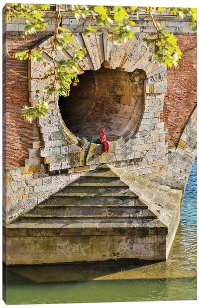 France, Toulouse. Red Devil sitting in opening of the Pont Neuf (Bridge) Canvas Art Print