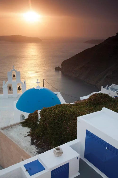 Greece, Santorini. Blue dome and bell tower at sunset