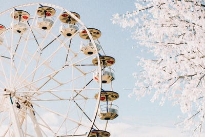 Blooming Cherry On The Background Of The Ferris Wheel In Spring by Ievgeniia Bidiuk canvas print