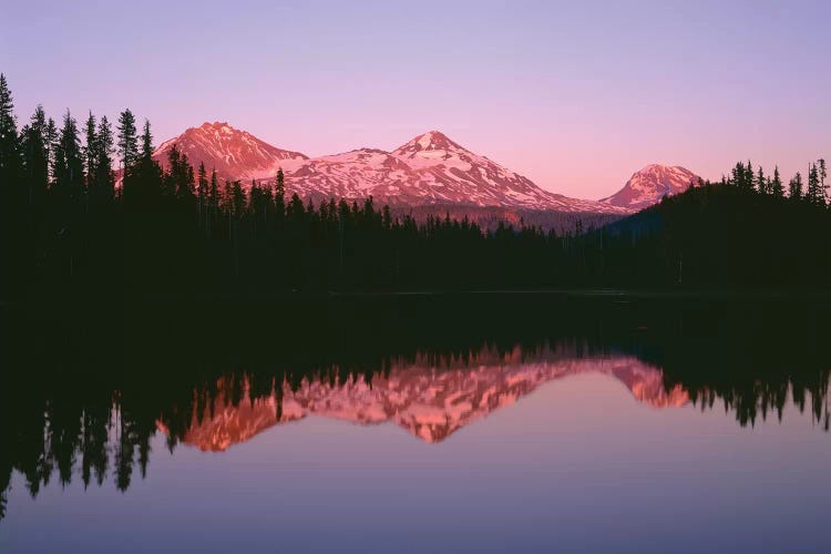 OR, Willamette NF. Sunset reddens the Three Sisters which reflect in Scott Lake.