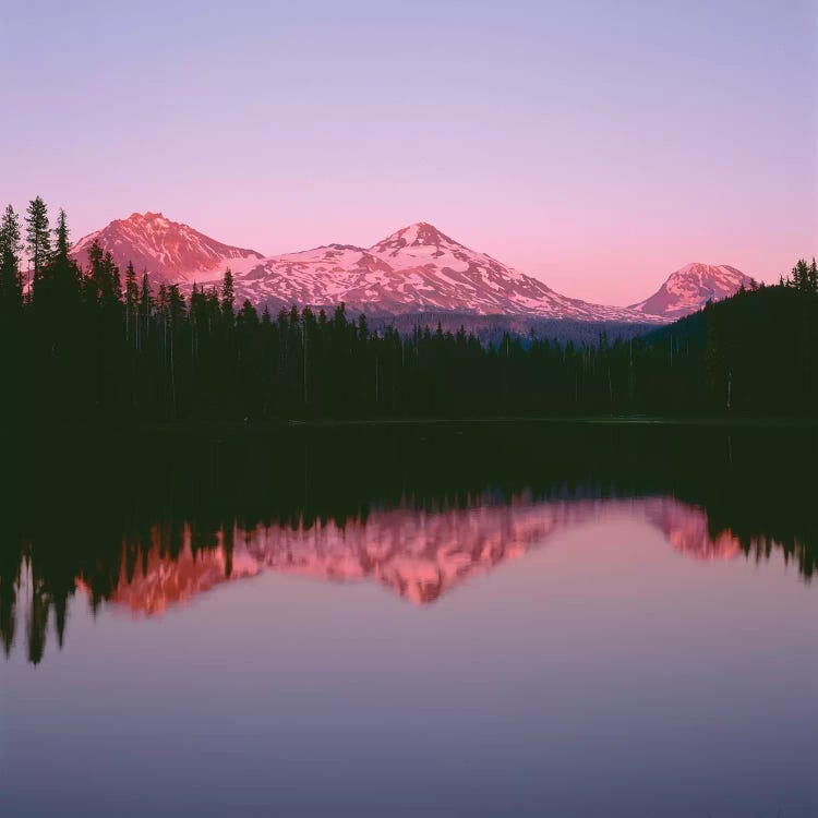 OR, Willamette NF. Sunset reddens the Three Sisters which reflect in Scott Lake.