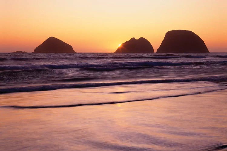 USA, Oregon, Oceanside Beach State Wayside. Sunset over Three Arch Rocks.