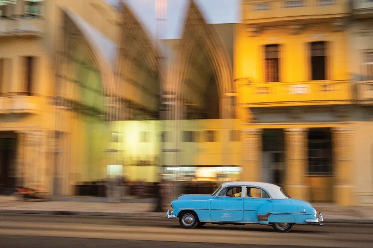 Cuba, Havana, classic car in motion at dusk on Malecon.