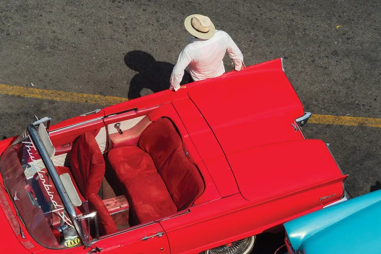 Cuba, Havana, Havana Vieja (Old Havana), red classic convertible and driver, viewed from above.