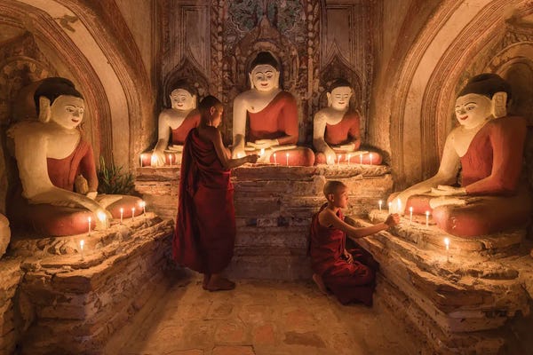 Buddhism: Two Young Novice Monks Praying To Buddha, Bagan, Myanmar by Jan Becke