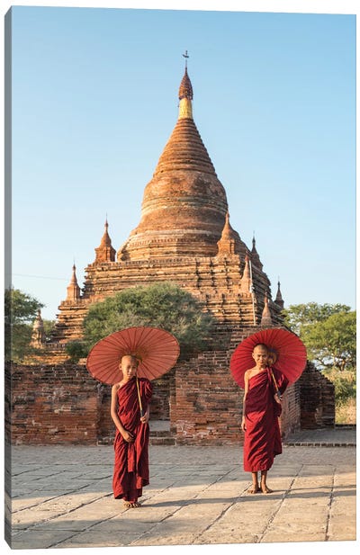 Two Young Novice Monks With Red Umbrellas Standing In Front Of A Temple, Bagan, Myanmar Canvas Art Print - Old Bagan