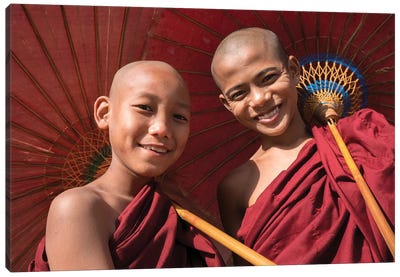 Two Young Buddhist Monks Smiling And Holding Red Umbrellas, Myanmar Canvas Art Print - Global Identities