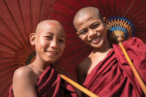 Burma (Myanmar): Two Young Buddhist Monks Smiling And Holding Red Umbrellas, Myanmar by Jan Becke