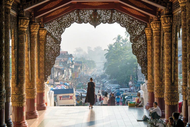 Buddhist Monk Passing The Entrance Of The Shwedagon Pagoda In Yangon, Myanmar